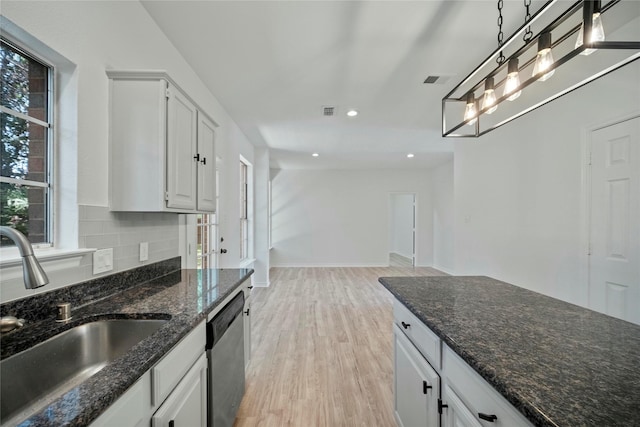 1100 Hyde Park Dr, Mckinney, TX 75069 - kitchen with a sink, stainless steel dishwasher, light wood-type flooring, white cabinetry, and hanging light fixtures
