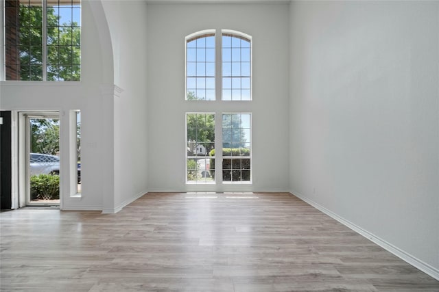 1100 Hyde Park Dr, Mckinney, TX 75069 - foyer entrance with healthy amount of natural light, a high ceiling, wood finished floors, and baseboards