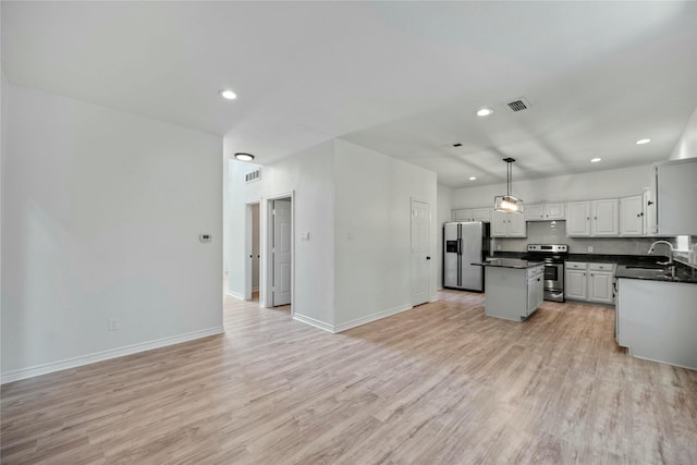 1100 Hyde Park Dr, Mckinney, TX 75069 - kitchen featuring stainless steel appliances, dark countertops, recessed lighting, open floor plan, and a center island