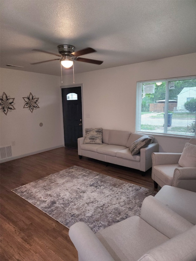 1104 Edgefield, Garland, TX 75040 - living room featuring a ceiling fan, wood finished floors, and a textured ceiling