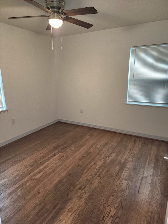 1104 Edgefield, Garland, TX 75040 - unfurnished room with dark wood-style flooring, a ceiling fan, plenty of natural light, and baseboards