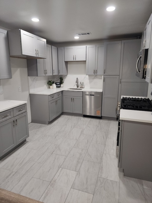 1104 Edgefield, Garland, TX 75040 - kitchen featuring stainless steel appliances, gray cabinetry, a sink, recessed lighting, and light countertops