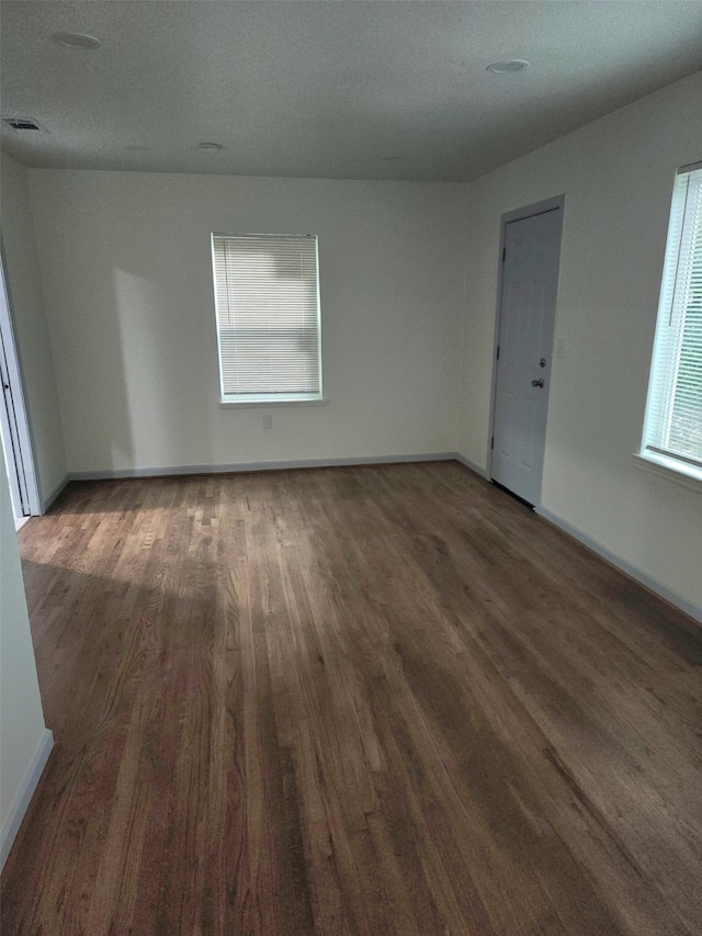 1104 Edgefield, Garland, TX 75040 - empty room featuring wood finished floors and baseboards