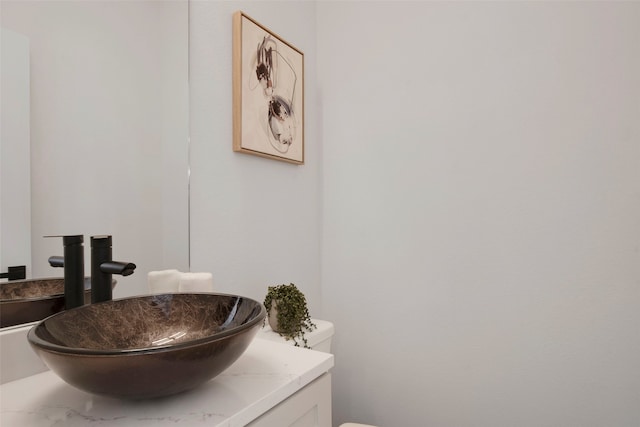 half bathroom with vanity and toilet