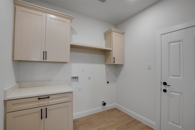 laundry room with electric dryer hookup, hookup for a gas dryer, cabinet space, light wood finished floors, and hookup for a washing machine