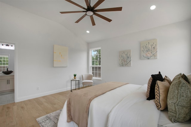 bedroom featuring lofted ceiling, multiple windows, recessed lighting, light wood-style flooring, and baseboards