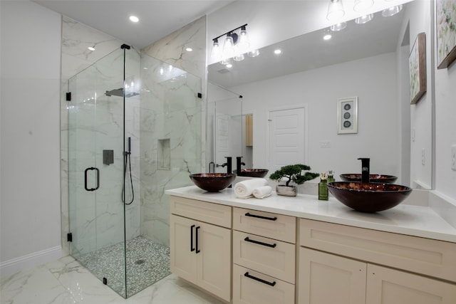 bathroom featuring marble finish floors, a marble finish shower, double vanity, recessed lighting, and baseboards