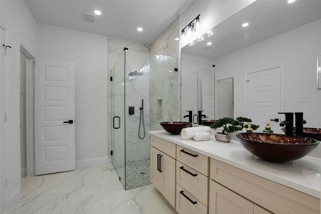full bathroom with a marble finish shower, recessed lighting, marble look tiles, double vanity, and baseboards