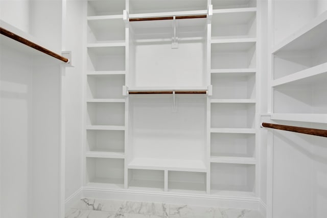 spacious closet with marble finish flooring