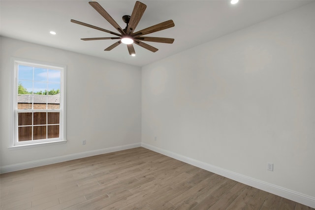 spare room featuring baseboards, light wood-style floors, recessed lighting, and a ceiling fan