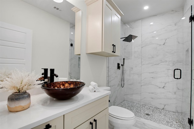 full bath featuring a marble finish shower, vanity, marble finish flooring, toilet, and recessed lighting