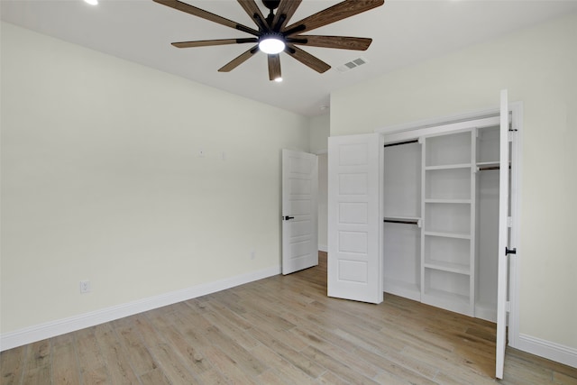 unfurnished bedroom featuring light wood-style floors, baseboards, a closet, and recessed lighting