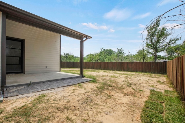 fenced backyard with a patio