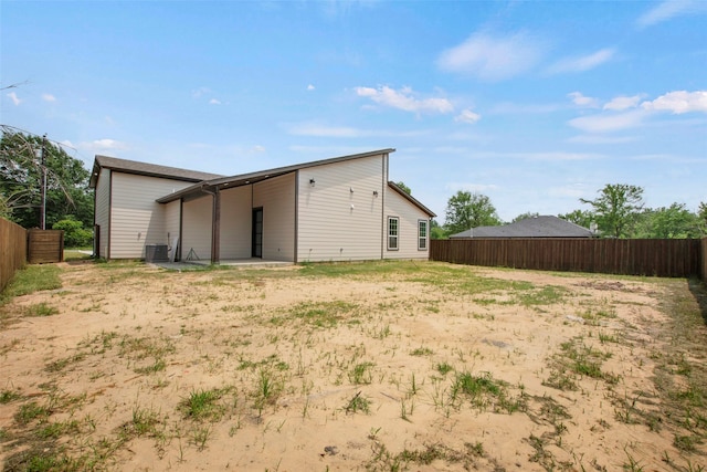 back of house featuring fence and cooling unit
