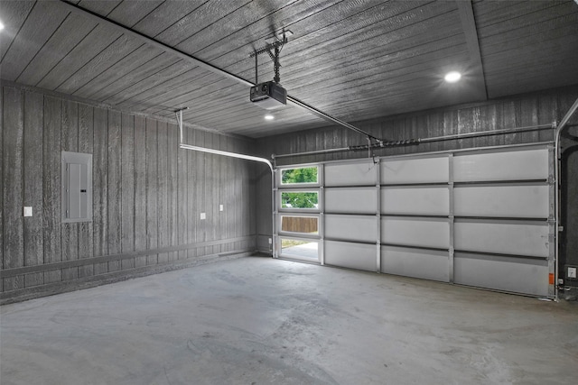 garage with a garage door opener and electric panel