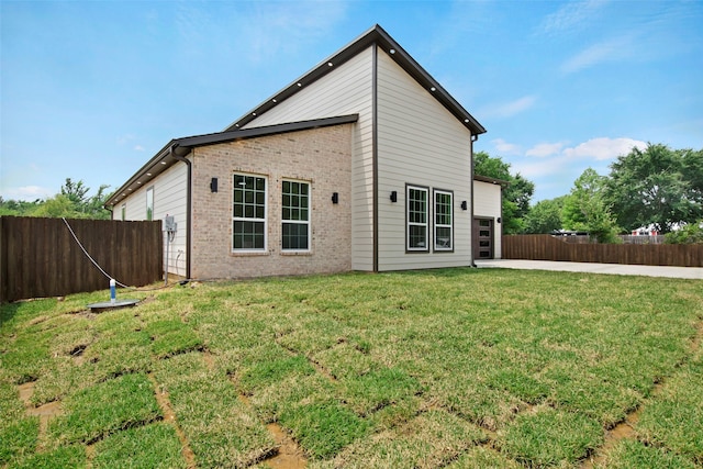 rear view of property with brick siding and a patio area