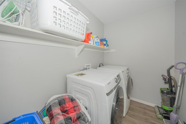 112 Wood St Unit A, Princeton, TX 75407 - laundry room with separate washer and dryer, wood finished floors, and baseboards