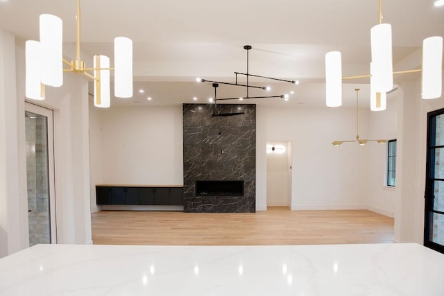 1596 Maple, Tyler, TX 75703 - unfurnished living room with a chandelier, wood finished floors, and baseboards