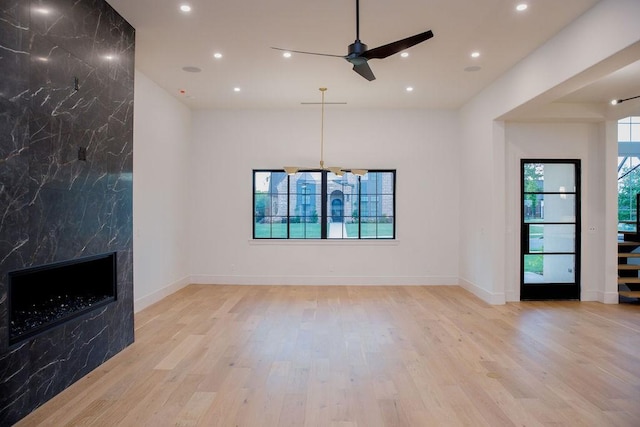 1596 Maple, Tyler, TX 75703 - unfurnished living room featuring wood finished floors, a ceiling fan, recessed lighting, a fireplace, and stairway