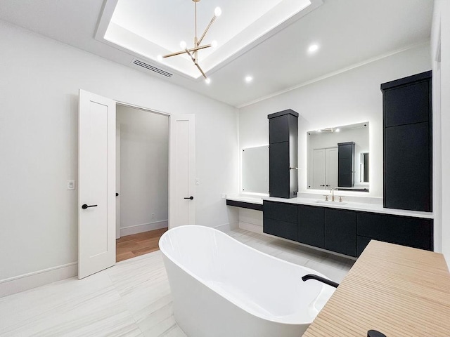 1596 Maple, Tyler, TX 75703 - full bath featuring a chandelier, a freestanding bath, vanity, recessed lighting, and baseboards