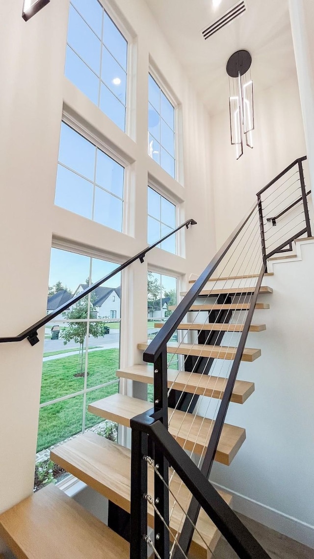 1596 Maple, Tyler, TX 75703 - stairs with a towering ceiling and a chandelier