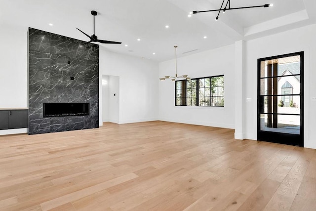 1596 Maple, Tyler, TX 75703 - unfurnished living room featuring a chandelier, a ceiling fan, light wood-type flooring, a fireplace, and recessed lighting