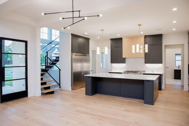 1596 Maple, Tyler, TX 75703 - kitchen with stainless steel appliances, a chandelier, a spacious island, light countertops, and modern cabinets