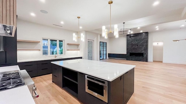 1596 Maple, Tyler, TX 75703 - kitchen with open shelves, modern cabinets, a sink, a chandelier, and light wood finished floors