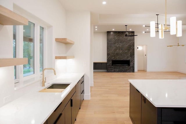 1596 Maple, Tyler, TX 75703 - kitchen featuring a sink, light wood finished floors, open shelves, decorative light fixtures, and modern cabinets