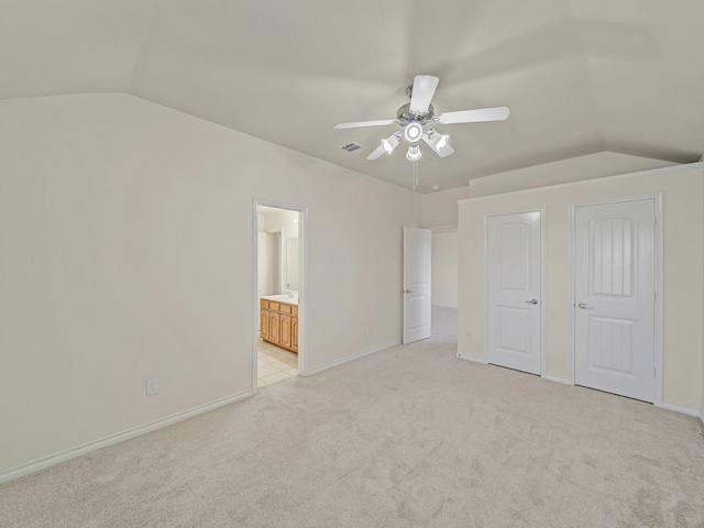 348 Kansas Trl, Murphy, TX 75094 - unfurnished bedroom with vaulted ceiling, light colored carpet, baseboards, connected bathroom, and a ceiling fan