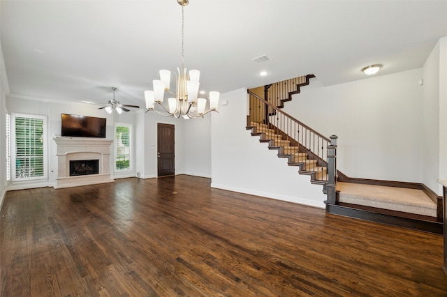 unfurnished living room featuring stairs, a ceiling fan, wood finished floors, a fireplace with raised hearth, and baseboards