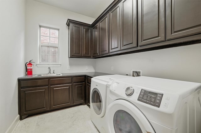 clothes washing area featuring cabinet space, washer and clothes dryer, light marble finish floors, and baseboards
