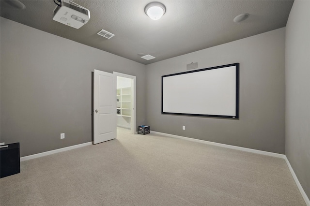 carpeted home theater featuring baseboards