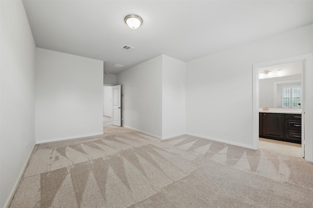 empty room with light colored carpet and baseboards