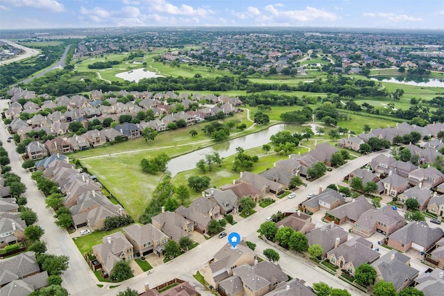 aerial view of residential area featuring a nearby body of water and a golf course