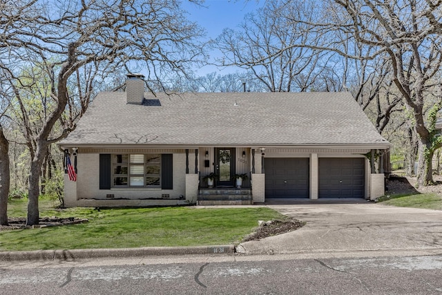 1031 S Fairbanks, Denison, TX 75020 - view of front of property featuring brick siding, a garage, a front yard, a chimney, and driveway