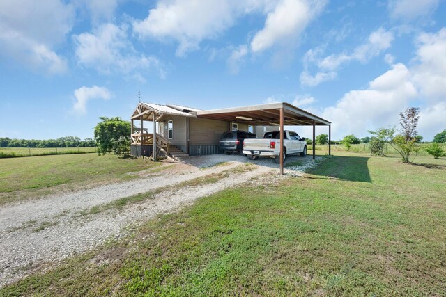 3266 Farm Rd Unit 1159, Clarksville, TX 75426 - view of side of home with driveway, a lawn, and an attached carport