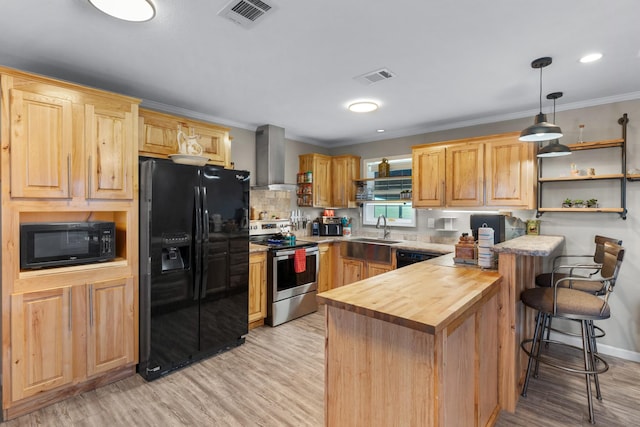 3266 Farm Rd Unit 1159, Clarksville, TX 75426 - kitchen featuring black appliances, wooden counters, wall chimney range hood, a peninsula, and a sink