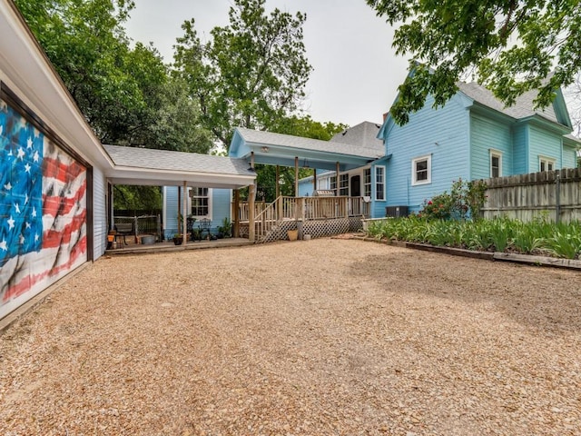 320 S Ward St, Italy, TX 76651 - back of house featuring fence, a wooden deck, and roof with shingles