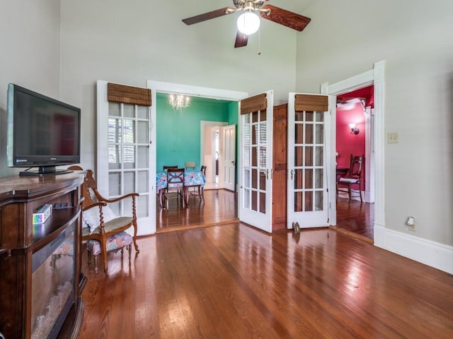 320 S Ward St, Italy, TX 76651 - living area featuring a towering ceiling, french doors, wood finished floors, a ceiling fan, and baseboards