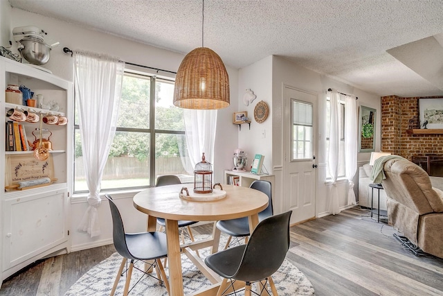 213 NE Timber Ridge Dr, Burleson, TX 76028 - dining room featuring a textured ceiling and light wood finished floors