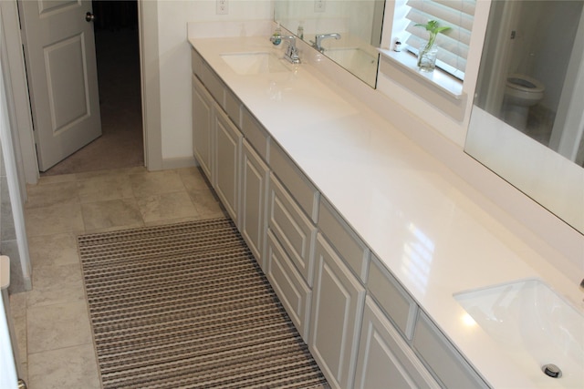 4804 Garner Dr, Carrollton, TX 75010 - full bathroom featuring double vanity and toilet