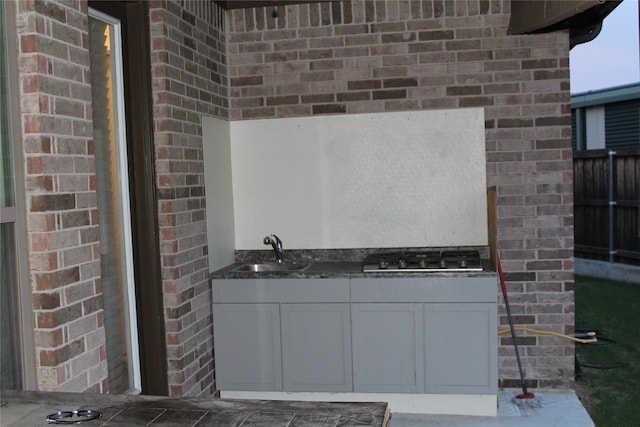 4804 Garner Dr, Carrollton, TX 75010 - bathroom featuring a sink and brick wall