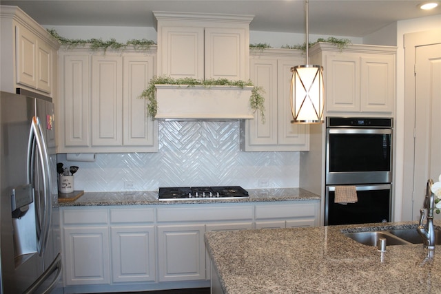 4804 Garner Dr, Carrollton, TX 75010 - kitchen featuring stainless steel appliances, white cabinets, and backsplash