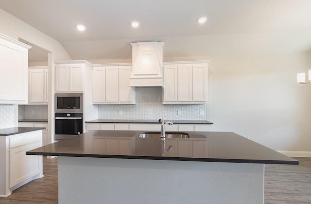 620 Alaina Dr, Desoto, TX 75115 - kitchen featuring stainless steel appliances, dark countertops, a sink, custom exhaust hood, and white cabinetry