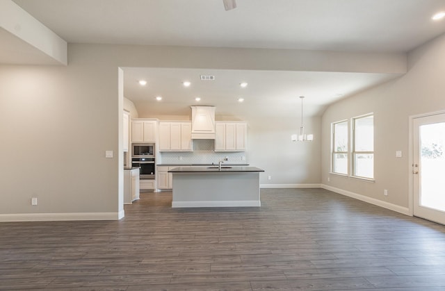 620 Alaina Dr, Desoto, TX 75115 - kitchen with built in microwave, oven, dark countertops, open floor plan, and custom range hood