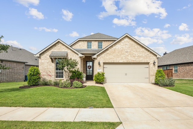 3120 Pioneer Path, Little Elm, TX 75068 - view of front of house featuring brick siding, a garage, driveway, and a front lawn
