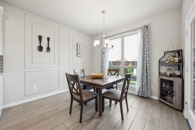 3120 Pioneer Path, Little Elm, TX 75068 - dining area featuring light wood-type flooring, a chandelier, and baseboards
