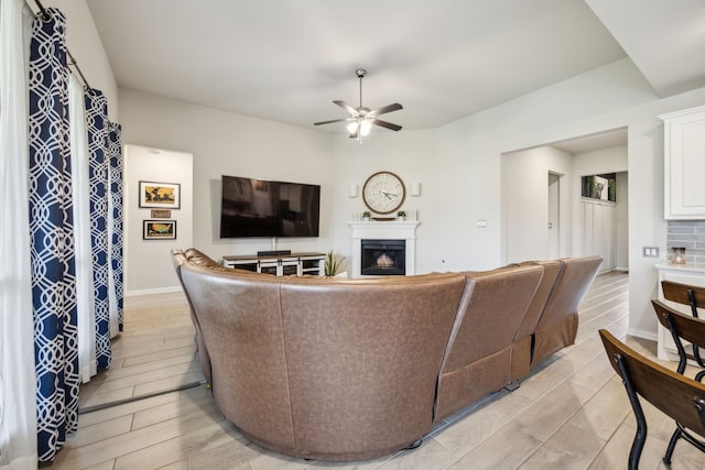 3120 Pioneer Path, Little Elm, TX 75068 - living area with a fireplace, a ceiling fan, wood finish floors, and baseboards
