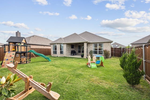 3120 Pioneer Path, Little Elm, TX 75068 - back of property featuring brick siding, a playground, a shingled roof, and a patio